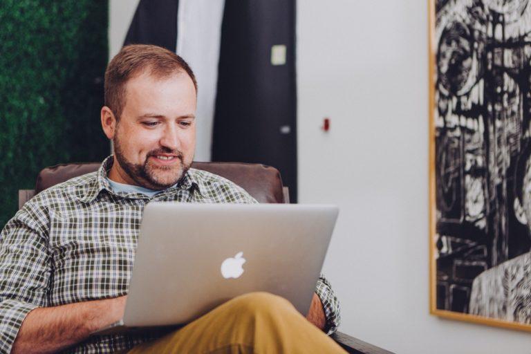 A guy browsing on a laptop