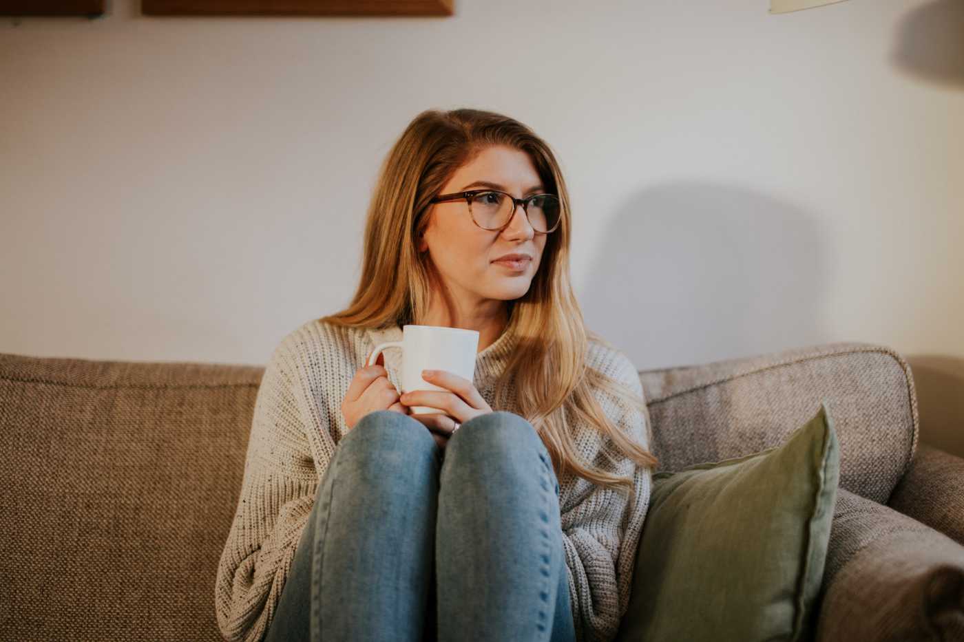 woman on couch thinking about her anxiety