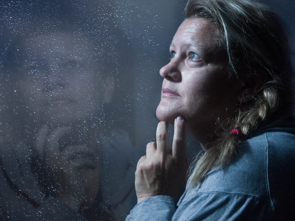 Woman Looking Out Window